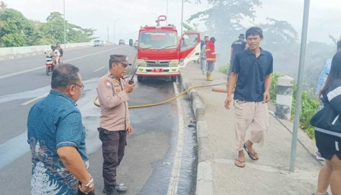 Polsek Bunaken Bersama Warga Gerak Cepat Padamkan Kebakaran Lahan di Molas